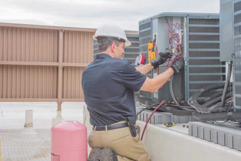 3 Tips to Prevent an AC Breakdown During a Heat Wave. HVAC tech