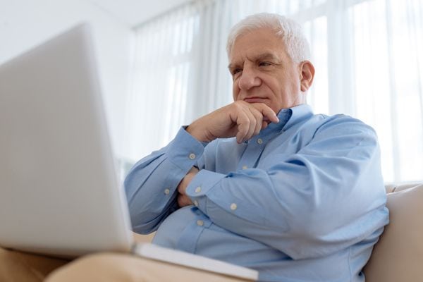 A man ponders while on a laptop. How Do I Know I Have a Cracked Heat Exchanger?