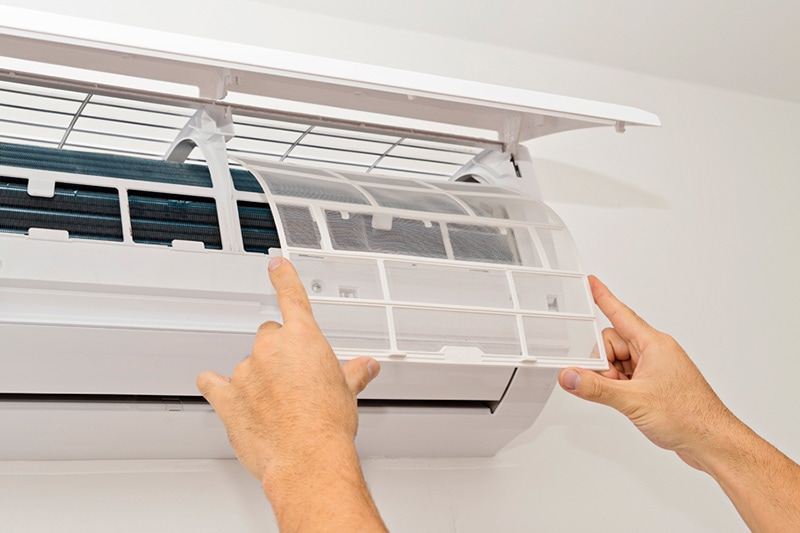 what maintenance is needed for a ductless system?, two hands repairing ductless ac system