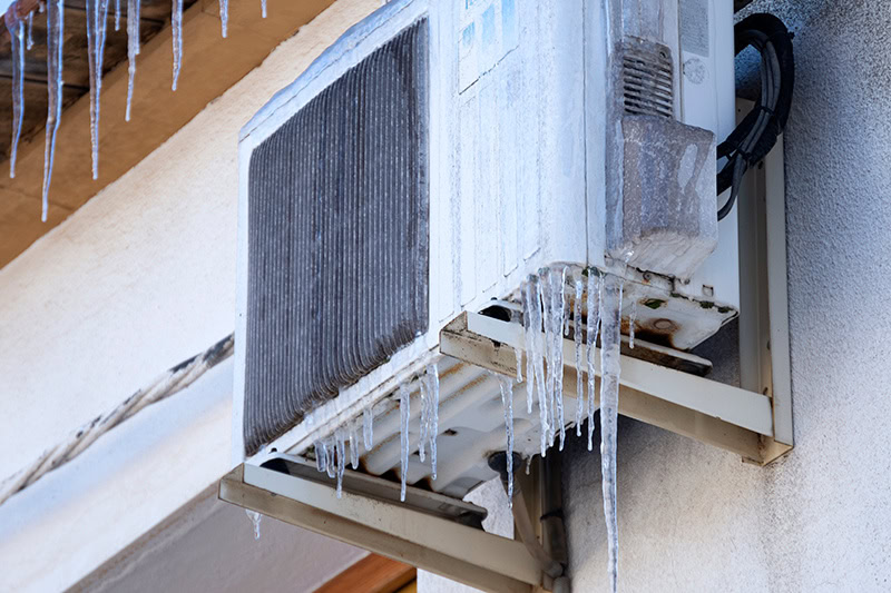 Why Is My Heat Pump Freezing Up? A heat pump that is covered in ice.